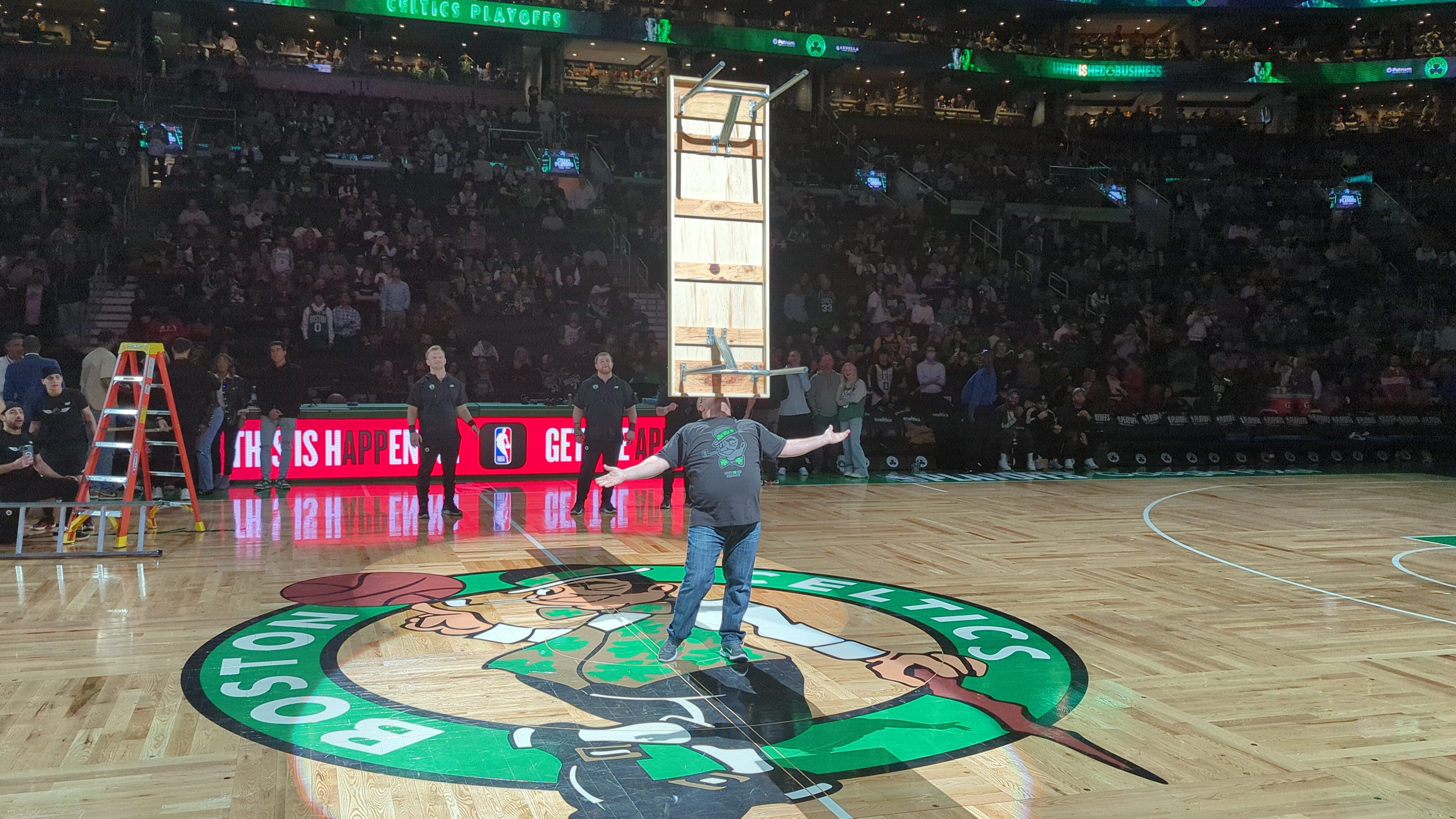 The Amazing Chin Balancer performing tall bookshelf balance at Celtics halftime show