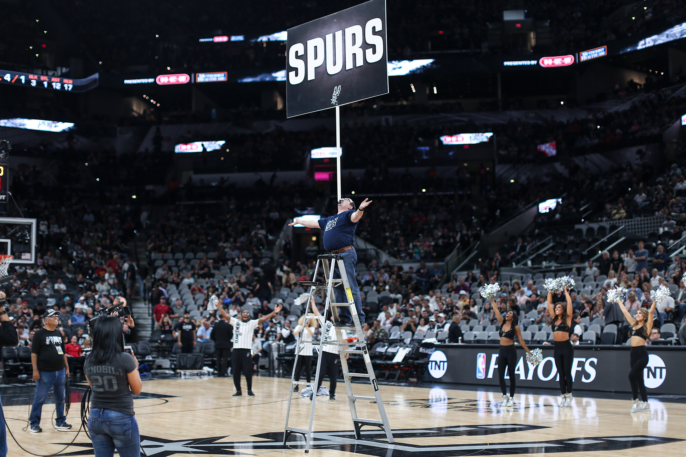 Kevin Shiflett balancing 16-foot ladder on chin at NBA arena halftime performance